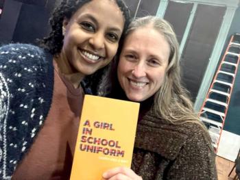 two women pose with playbill
