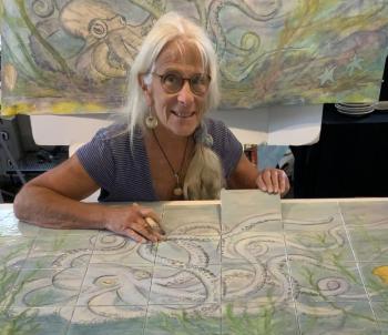 female shows tile mural