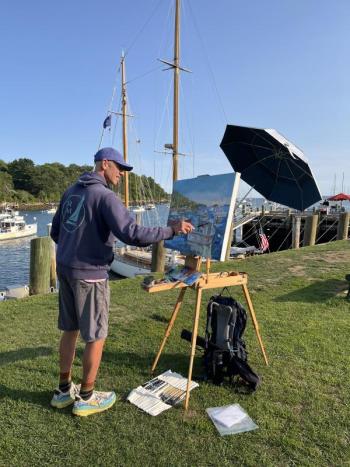 man painting at easel