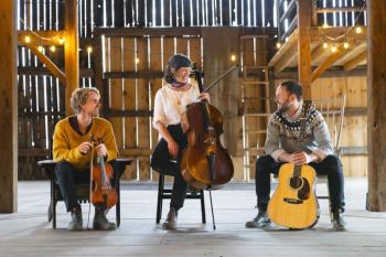 three musicians sitting in different seats