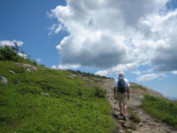 hiker climbing toward peak