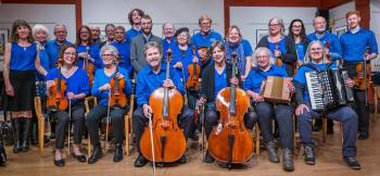 members of large band, all wearing blue shirts