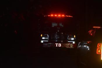 front of fire truck, rear of chief's vehicle