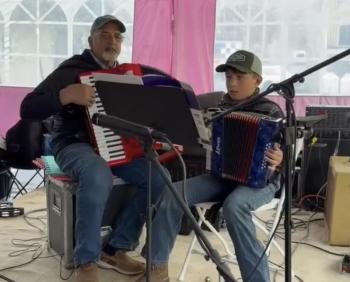 Eric Tolman and his grandson, Ben Tolman, play the accordion in honor of David Dickey (Photo courtesy Monica Tolman)