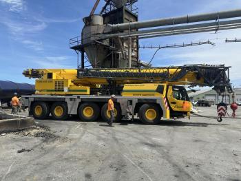 yellow crane truck at lumber yard