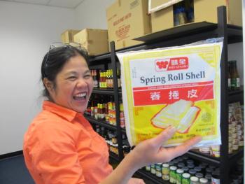 Glo's Market owner Claire Fuller displays the wrapping make up her famous Filopeno lumpia. Photo by Kay Stephens