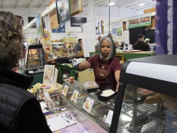 Concepta serving customers at her food stand. Photo by Kay Stephens