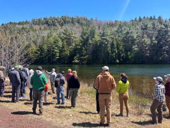 workshop participants at a pond