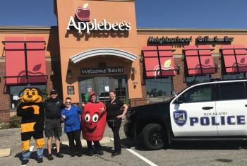 mascots, police cruiser outside restaurant