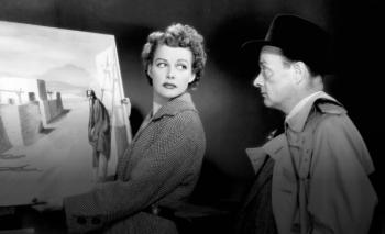 woman shows man a painting