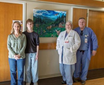 People pose in front of Woodland Lullabies painting