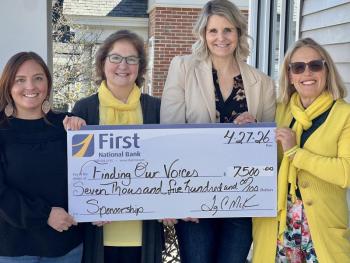 four women hold presentation check