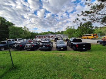 Cars begin to fill the lot at Edna Drinkwater School in Northport. (photo by Erica Thoms)