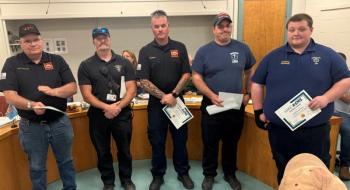 5 males pose with certificates of acknowledgement