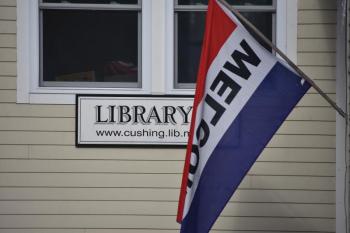 library sign and welcome flag