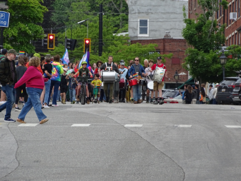 The start of the parade comes into view as beating drums announce their arrival. 