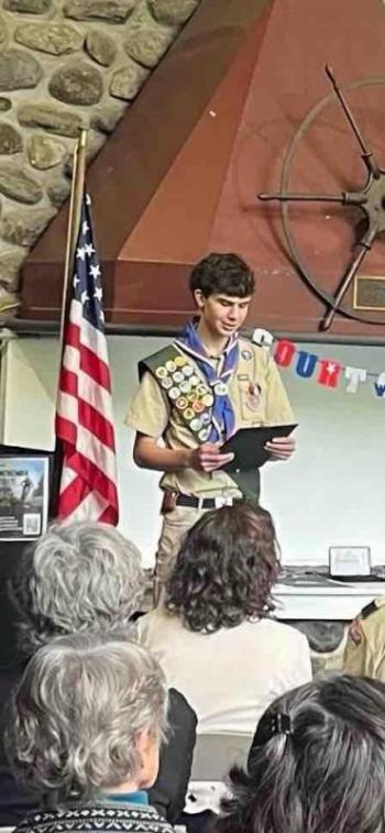 Scout looks at award during ceremony