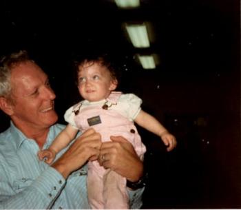 adult man holding toddler girl