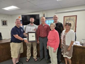 presenting framed acknowledgement