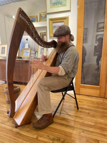 man plays harp