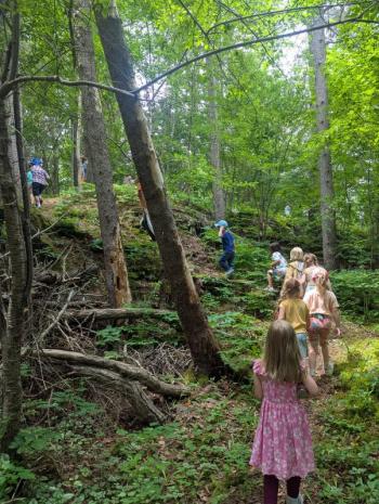 children walk up a trail