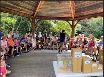 large group of people seated in gazebo