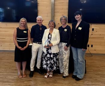 Five adults pose for picture
