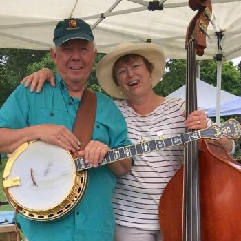 man, woman with banjo, guitar
