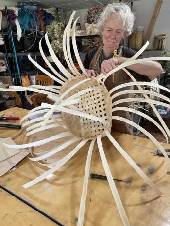 woman weaves basket