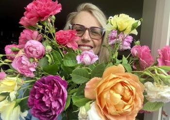 woman poses with roses