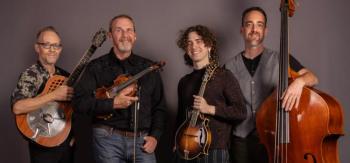 four people pose with instruments