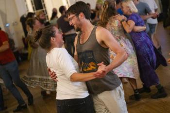 man, woman dance close