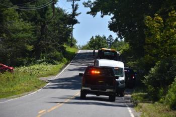 emergency vehicles face crest of hill