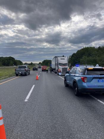 vehicles parked on highway with wrong-way facing tractor trailer truck