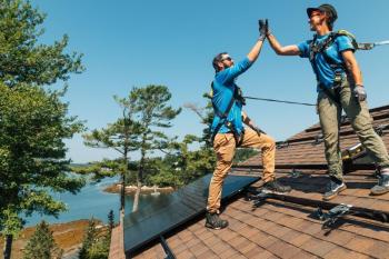 two men on roof hi-five
