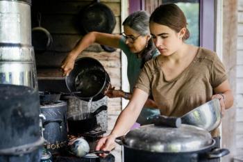 two women handling pots