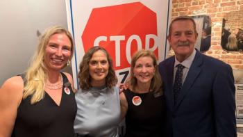 three women, man pose for picture
