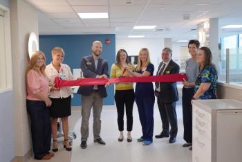 eight adults at ribbon cutting