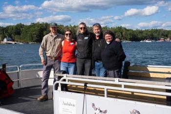 people pose for picture in boat