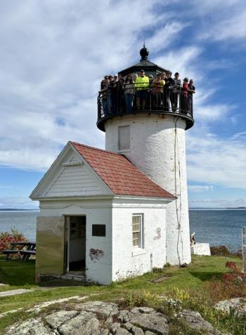 portrait format of lighthouse with group on tower