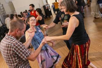 four people in circle dance