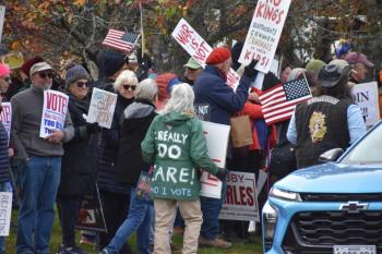 crowd, words on back of green coat