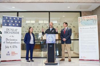 three people at lectern