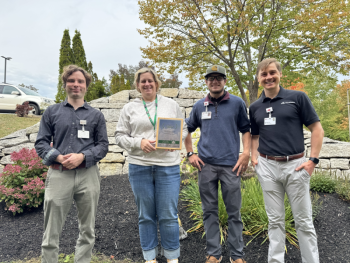 four people in front of garden