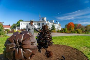 man, sculptures, Blaine House in background