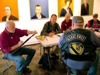 Dwayne Keller, foreground, a Vietnam War veteran, sits for portraits by artists, from left, Robert Shetterly, Kenny Cole and Charlene Decker during an Armistice/Veterans Day draw-a-thon.