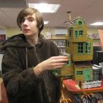 Tylor Cumler, artist and his Baba Yaga chicken feet house. Photo by Kay Stephens