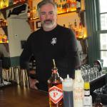 8 Bells co-owner Tom Ryan stand behind the ingredients which will make up their signature Irish Old Fashioned, The 8 Bells. Photo by Kay Stephens