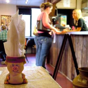 A napkin holder makes a playful nod to the giver of pulled pork, ribs and other staple menu items at Pig Out BBQ, a southern-style barbecue restaurant that opened on Marshall Wharf in Belfast in July. (Photo by Ethan Andrews)