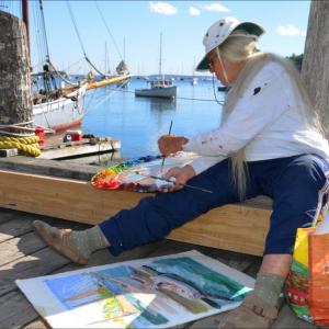 Judy Kohn concentrates on her canvas at Rockport Harbor, Sept. 23. (Photo by Lynda Clancy)